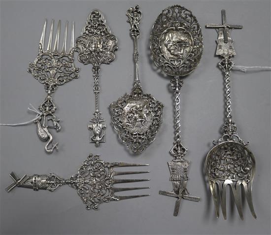 A Dutch silver spoon and fork set, with pierced and embossed decoration and windmill finials and four similar items